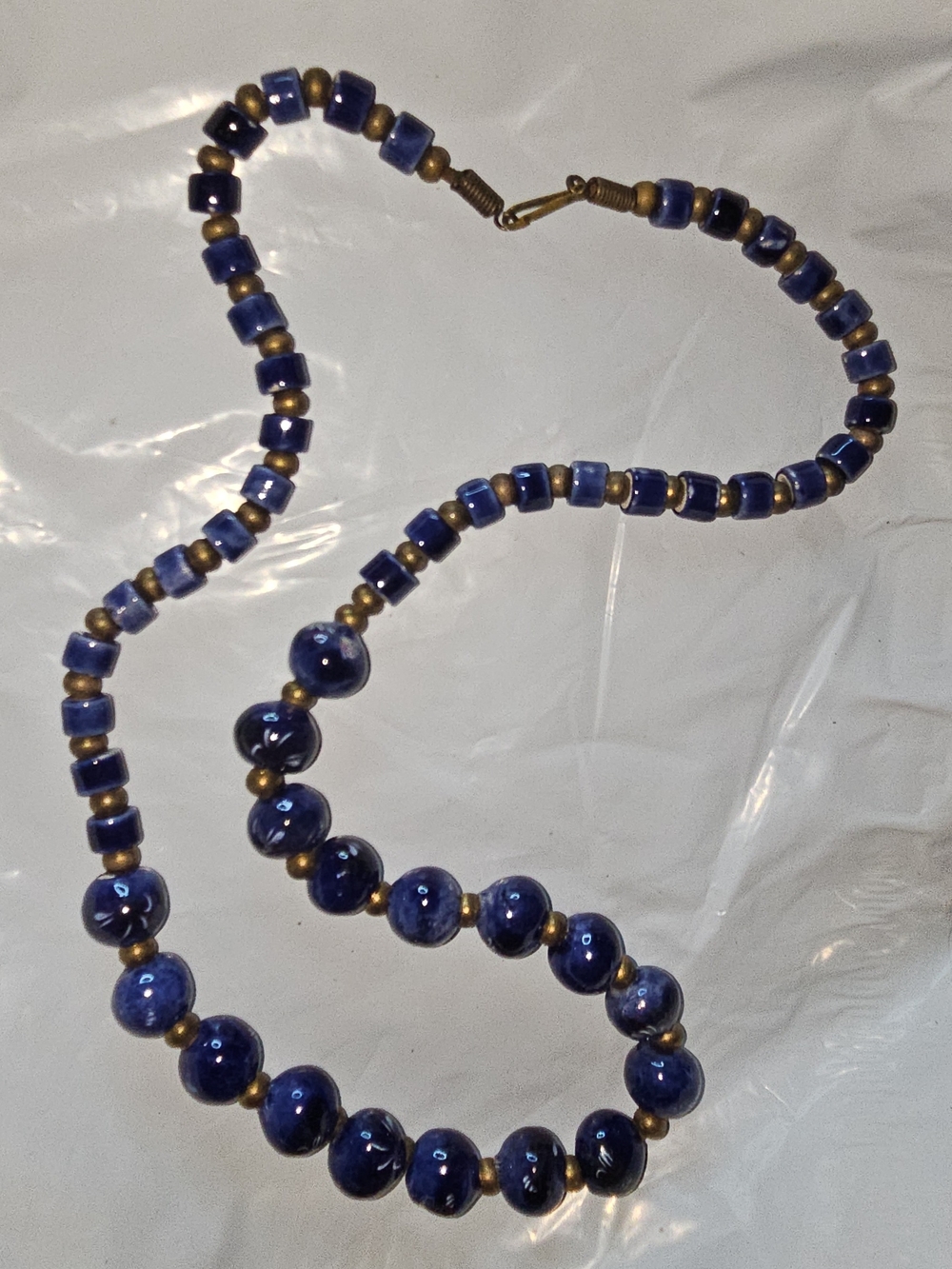 vintage bohemian necklace features cobalt blue ceramic beads with brass